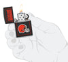 NFL Cleveland Browns Windproof Lighter lit in hand.