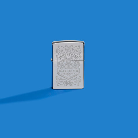 Lifestyle image of Zippo Johnny Cash High Polish Chrome Windproof Lighter on a blue background.
