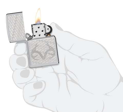 Zippo RealTree High Polish Chrome Windproof Lighter lit in hand.