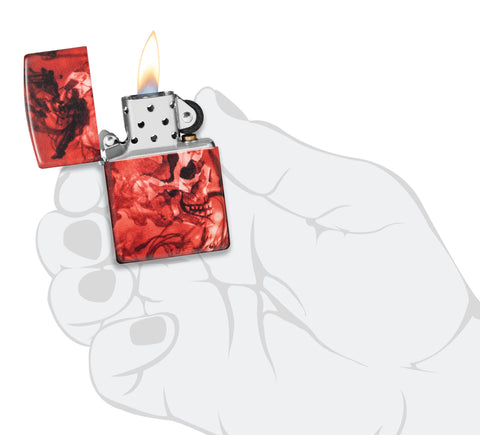 Zippo Spooky Skulls 540 Matte Windproof Lighter lit in hand.