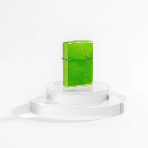 Lifestyle image of Zippo Classic Lurid Windproof Lighter on a clear pedestal and a white background.