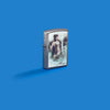 Lifestyle image of Zippo Luis Royo Street Chrome Windproof Lighter on a blue background.