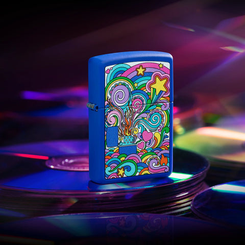 Lifestyle image of Zippo Abstract Design Royal Blue Matte Windproof Lighter sitting on a stack of CDs.
