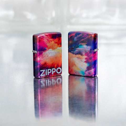 Lifestyle image of two Zippo Tie Dye Design 540 Tumbled Chrome Windproof Lighters on a reflective glass block background.