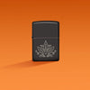 Lifestyle image of Zippo Cannabis Design High Polish Black Windproof Lighter on an orange ombre background.