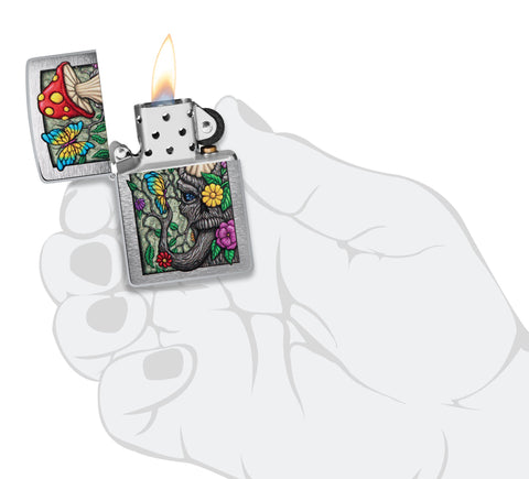 Zippo Freaky Nature Design Brushed Chrome Windproof Lighter lit in hand.