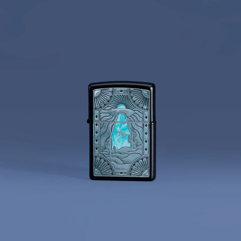 Lifestyle image of Zippo Cow Abduction Design Black Matte Windproof Lighter on a blue background.