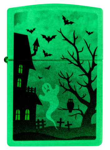 Front view of Zippo Spooky Design Glow in the Dark Green Windproof Lighter glowing in the dark.