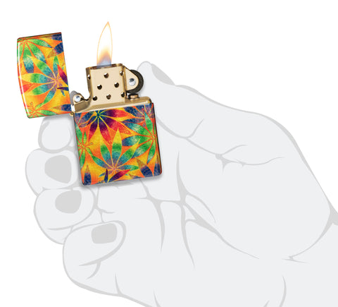 Zippo Cannabis Design 540 Tumbled Brass Windproof Lighter lit in hand.