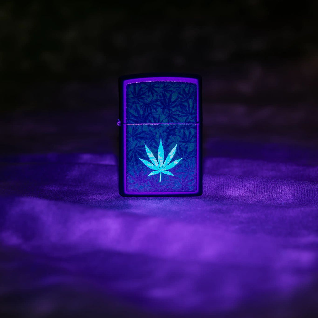 Zippo Cannabis Design Black Light Black Matte Windproof Lighter glowing in a black light.