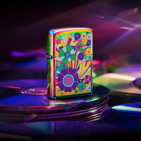 Lifestyle image of Zippo Vintage Flowers Design Multi-Color Windproof Lighter sitting on a stack of CDs.