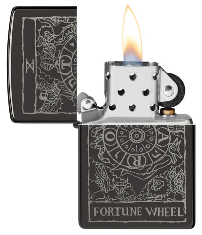 Zippo Wheel of Fortune Design High Polish Black Windproof Lighter with its lid open and lit.