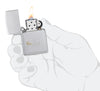 Zippo Love Design Satin Chrome Windproof Lighter lit in hand.