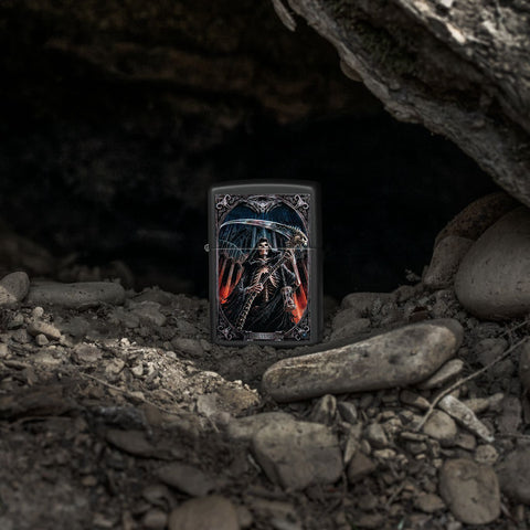 Lifestyle image of Zippo Anne Stokes Final Verdict Black Matte Windproof Lighter standing on a rocky background.