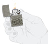 Zippo Pattern Armor Antique Silver Windproof Lighter lit in hand.