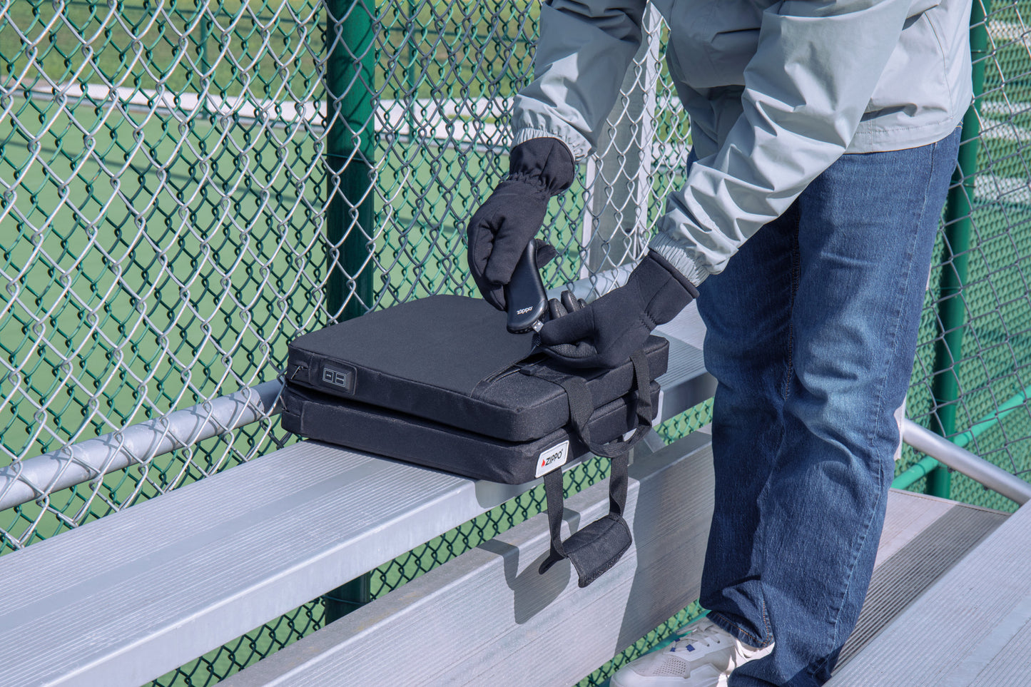 Lifestyle image of Zippo Heated Seat - Double with a man plugging in the HeatBank® 9 (not included)