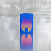 Lifestyle image of Zippo Design Royal Blue Matte Windproof Lighter on a reflective glass block background.