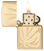 Zippo Leaf Feather Design High Polish Brass Windproof Lighter with its lid open and lit.