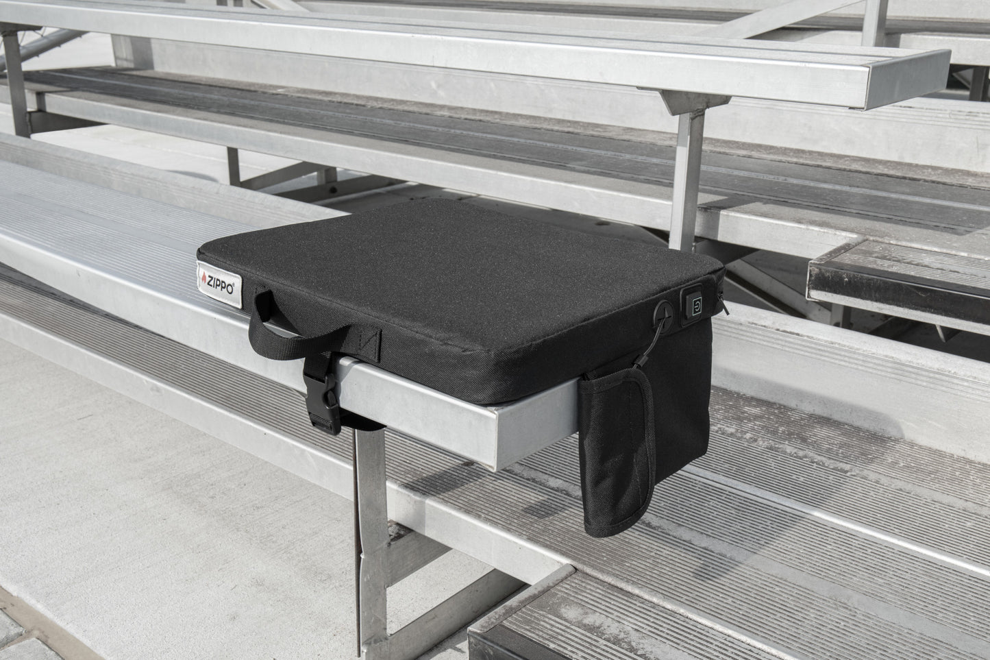 Bottom view of Zippo Heated Seat - Single showing the bottom side of the seat sitting on a bleacher.