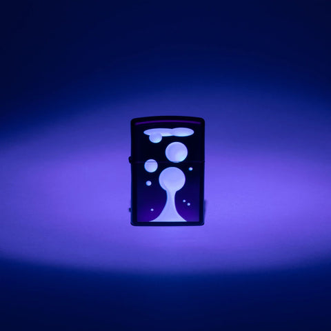 Lifestyle image of Zippo Black Light Lava Lamp Design Black Matte Windproof Lighter with the black light design glowing.