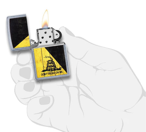 Front view of the Don't Tread on Me Lighter in hand, open and lit