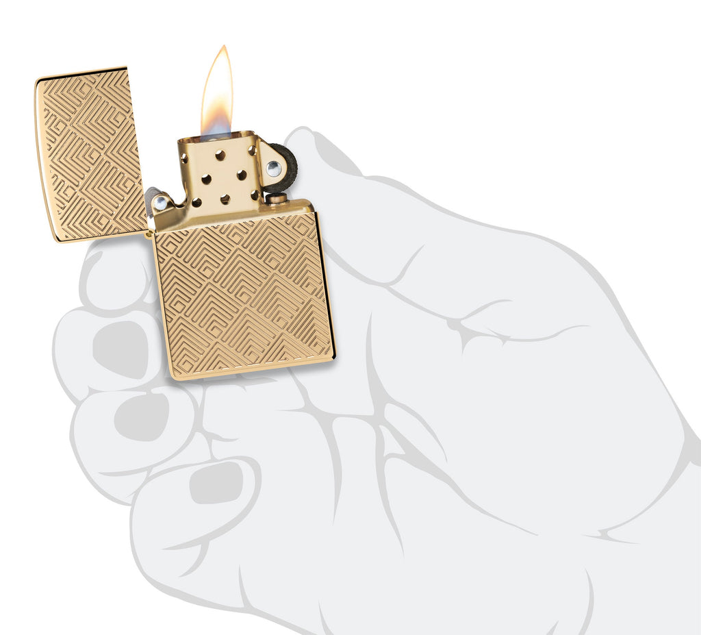 Zippo Pattern Design Armor High Polish Brass Windproof Lighter lit in hand.
