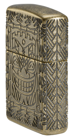 Tiki Design Armor® Antique Brass Windproof Lighter standing at an angle, showing the front and right side of the lighter.