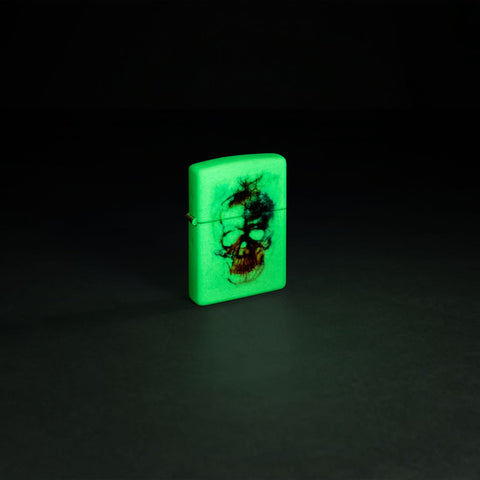 Glamour shot of Zippo Skull Print Design Glow in the Dark Matte Windproof Lighter glowing in the dark.