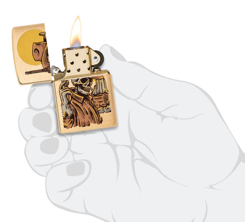 Zippo Wild West Skeleton Design Brushed Brass Windproof Lighter lit in hand.