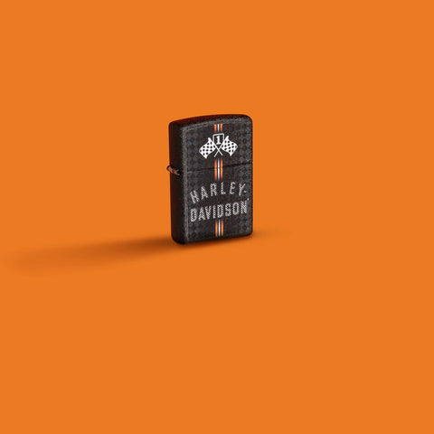 Glamour shot of Zippo Harley-Davidson Checkered Flags Design Black Crackle Windproof Lighter standing in an orange scene.