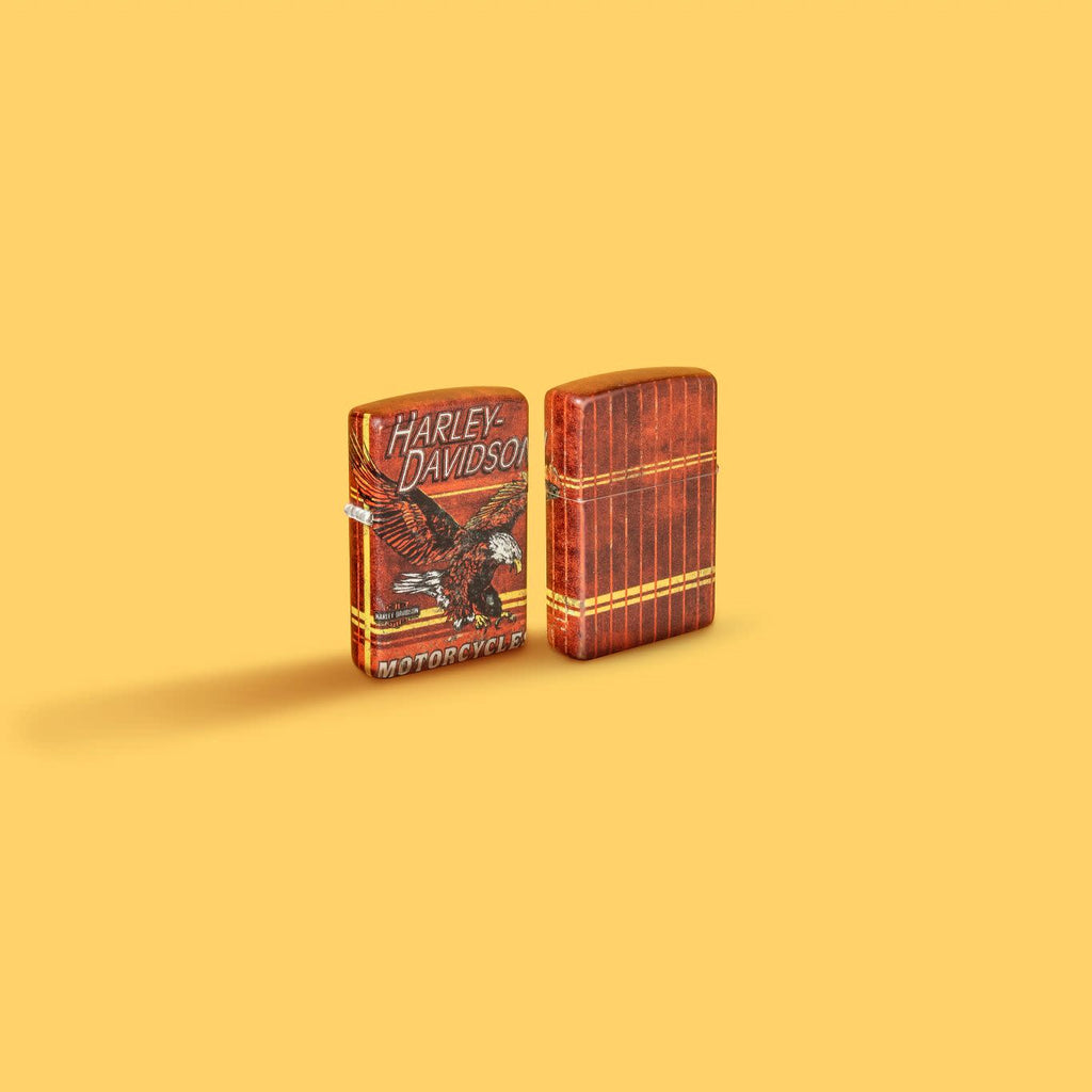 Glamour shot of Zippo Harley-Davidson Eagle 540 Color Windproof Lighter standing in a yellow scene.