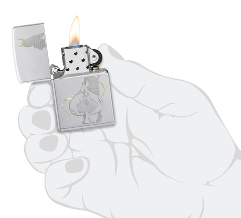 Zippo Devilish Ace Design Satin Chrome Windproof Lighter lit in hand.