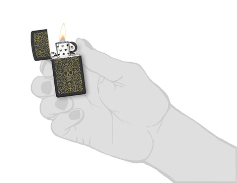 Zippo Skull Filigree Design Slim Black Matte Windproof Lighter lit in hand.