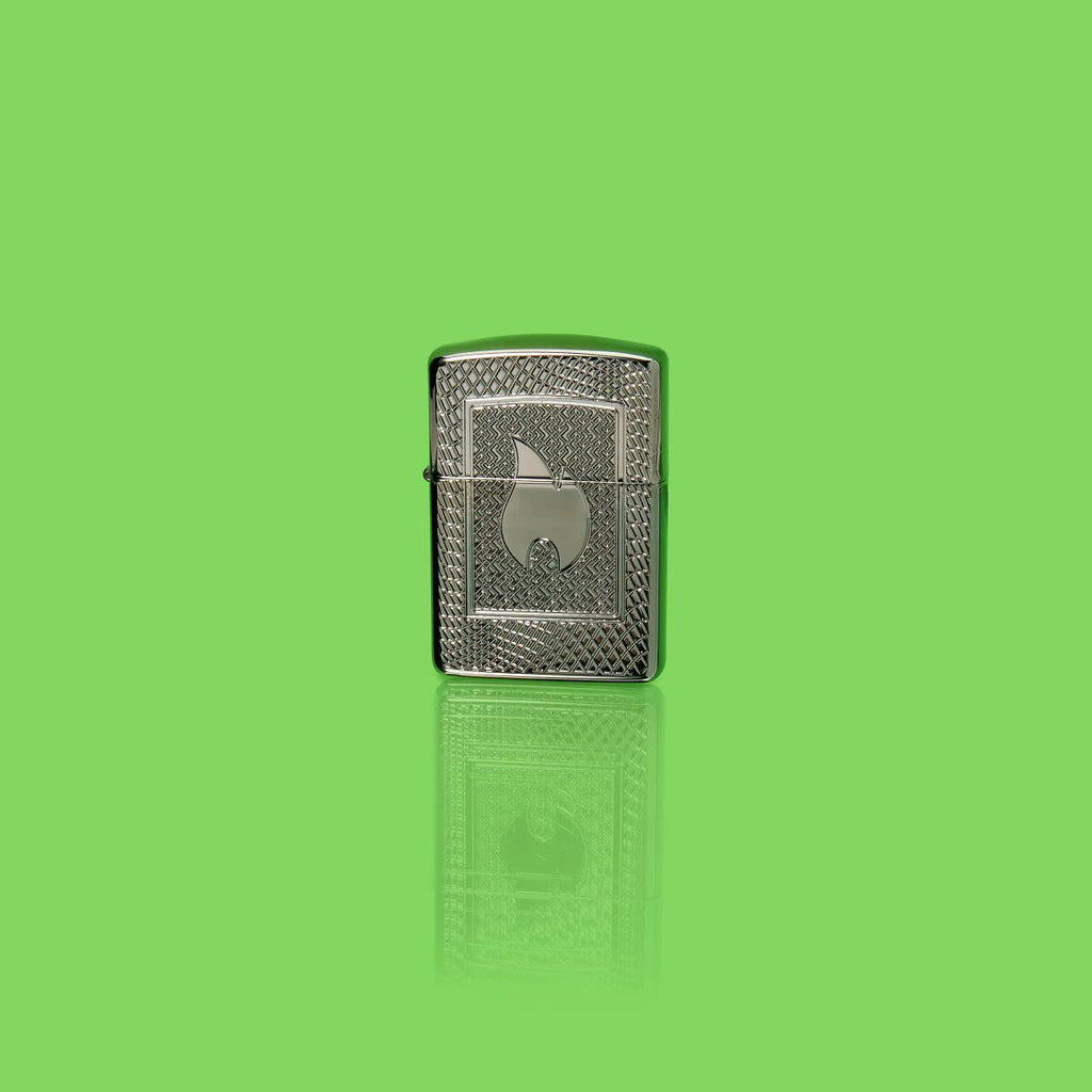 Glamour shot of Zippo Flame Pattern Design Armor Black Ice Windproof Lighter standing in a green scene.