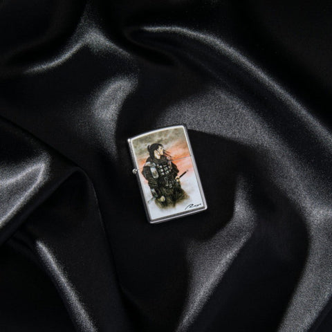 Lifestyle image of Luis Royo Samurai Design Street Chrome™ Windproof Lighter laying on a black cloth.