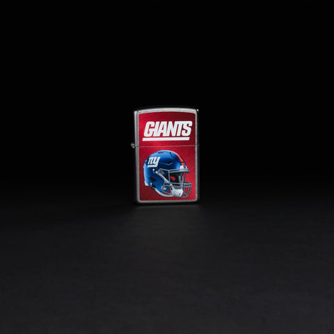 Lifestyle image of NFL New York Giants Helmet Street Chrome Windproof Lighter standing in a black background.