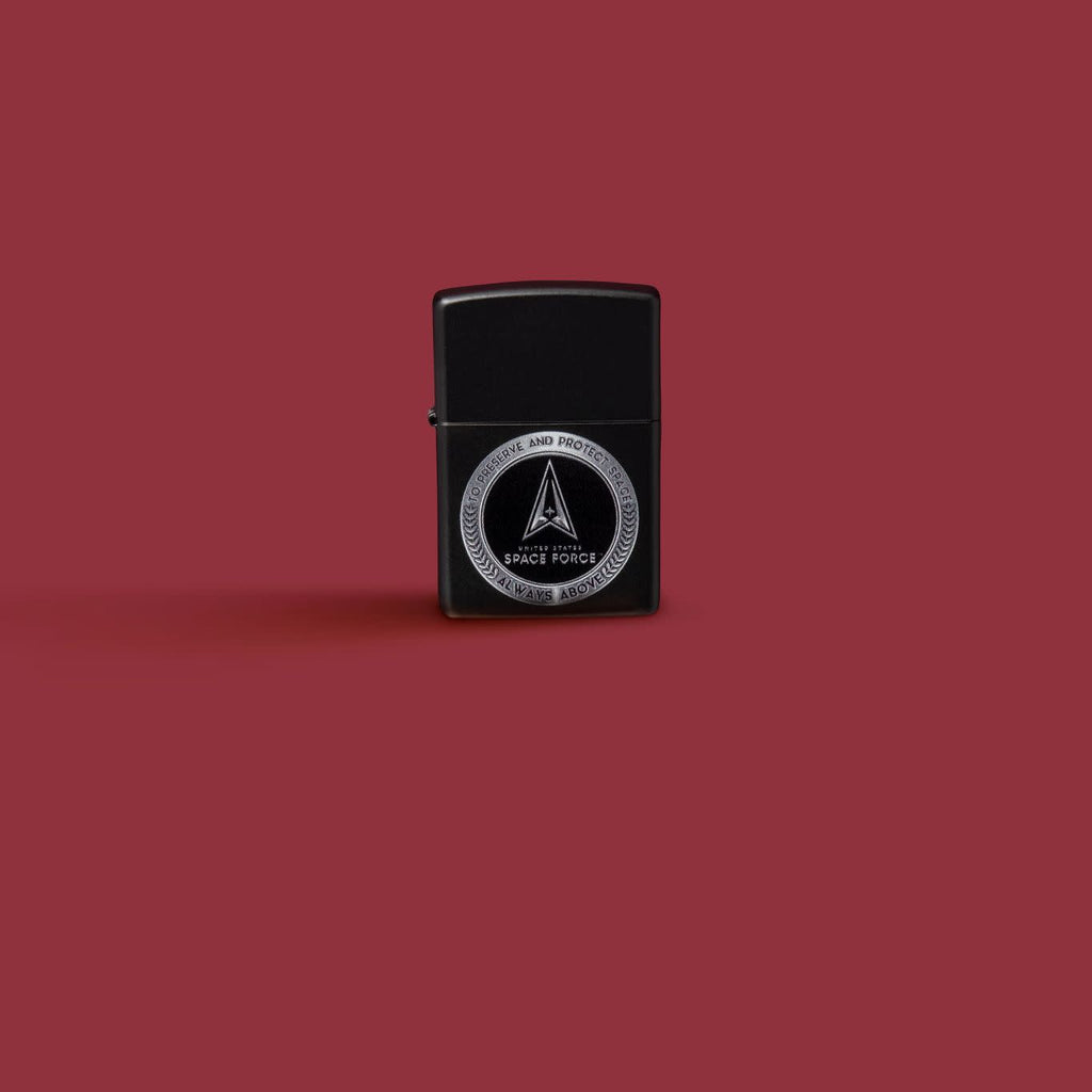 Glamour shot of Zippo U.S. Space Force Design Black Matte Windproof Lighter standing in a red scene.