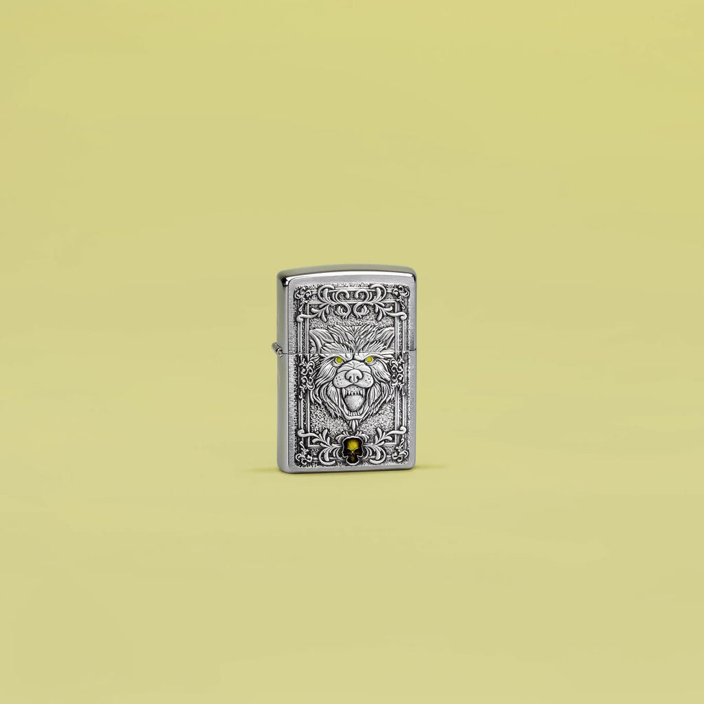 Lifestyle image of Zippo Wolf Emblem Design Brushed Chrome Windproof Lighter standing in a yellow scene.