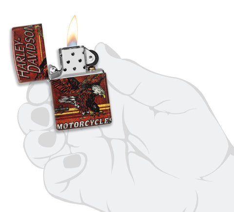 Zippo Harley-Davidson Eagle 540 Color Windproof Lighter lit in hand.
