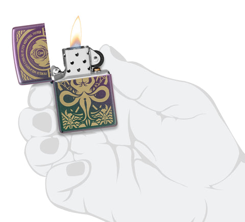 Zippo Evil Design Iridescent Windproof Lighter lit in hand.