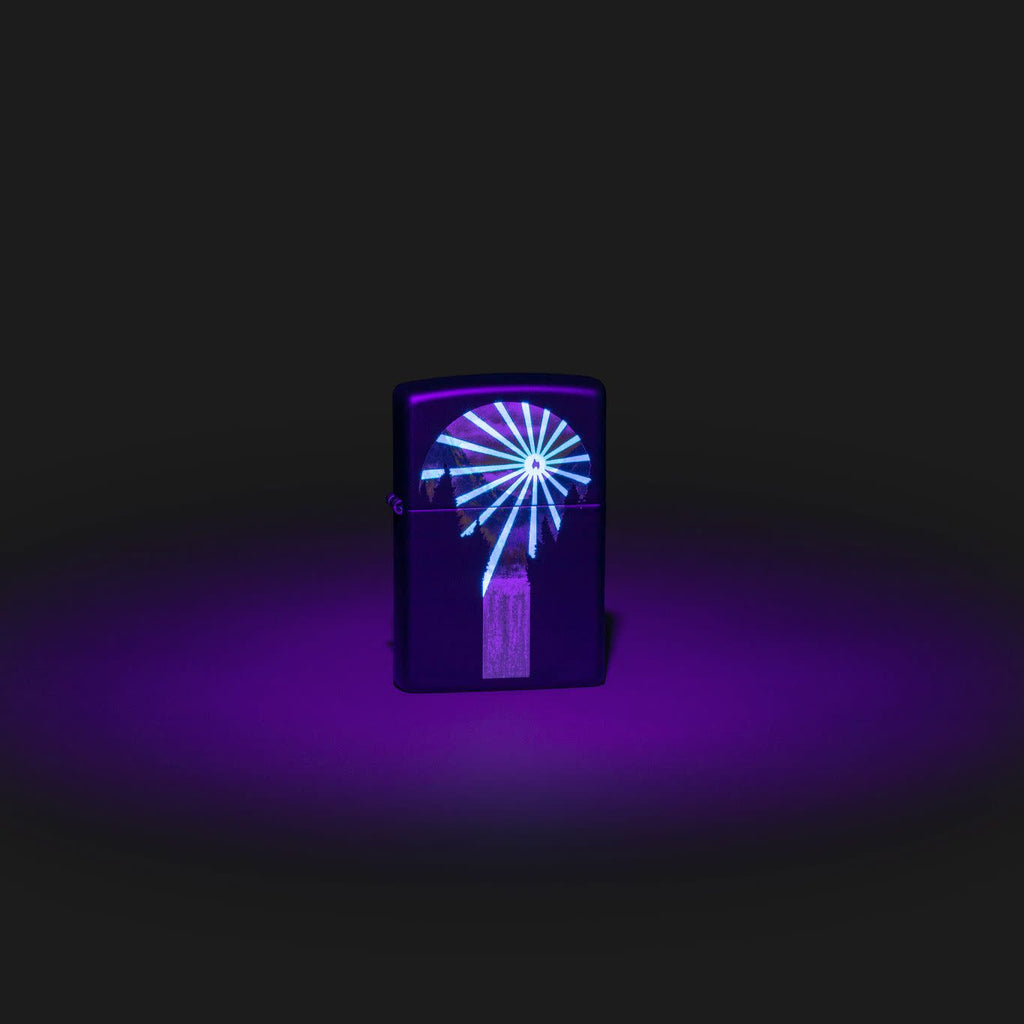 Lifestyle image of Zippo Black Light Lava Lamp Design Black Matte Windproof Lighter with the black light design glowing.