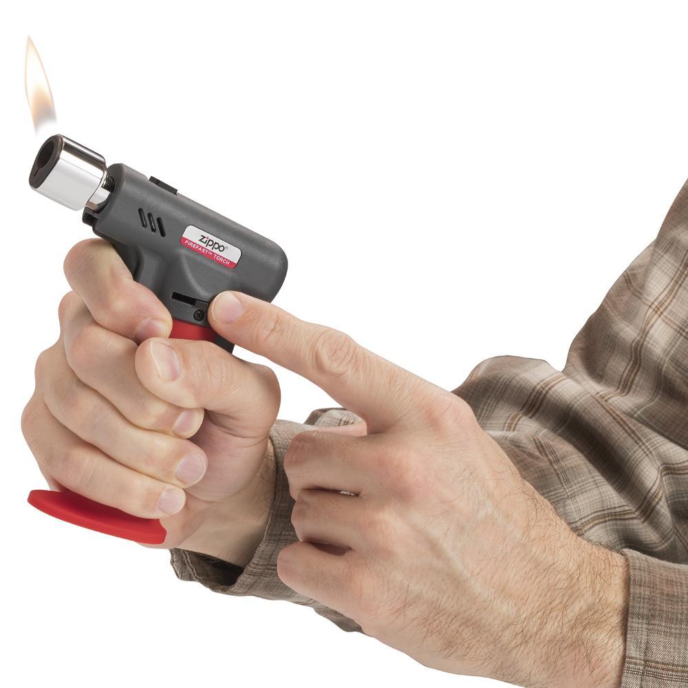 Firefast® Torch lit in hand, showing the adjustable flame size wheel