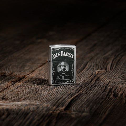 Lifestyle image of Zippo Jack Daniels Street Chrome Windproof Lighter standing on a wooden table.