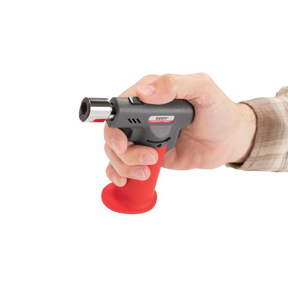 Firefast® Torch in hand, showing the switch that allows you to switch between a soft yellow or blue flame torch