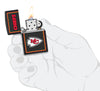 NFL Kansas City Chiefs Windproof Lighter lit in hand.