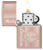Zippo Harley-Davidson® High Polish Rose Gold Windproof Lighter with its lid open and lit.