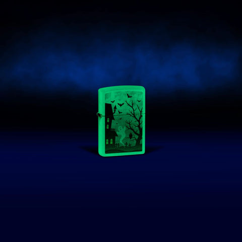 Lifestyle image of Zippo Spooky Design Glow in the Dark Green Windproof Lighter glowing in the dark.