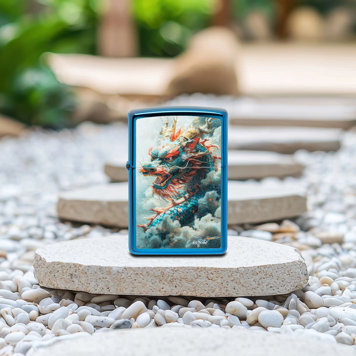 Lifestyle image of Zippo MazziÂ® Dragon Design High Polish Blue Windproof Lighter standing on a stepping stone on a garden path.