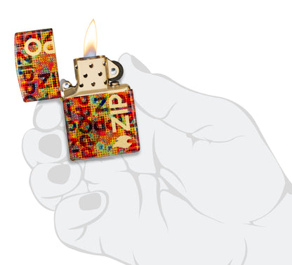 Zippo Pixel Fusion Design 540 Tumbled Brass Windproof Lighter lit in hand.