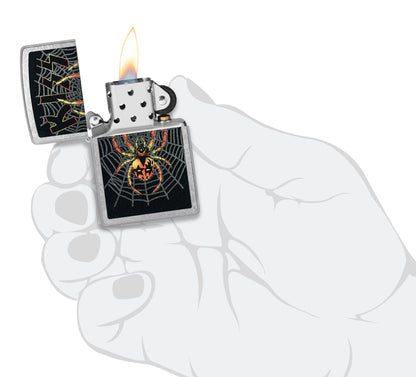 Zippo KISS® Spider Design Street Chrome Windproof Lighter lit in hand.